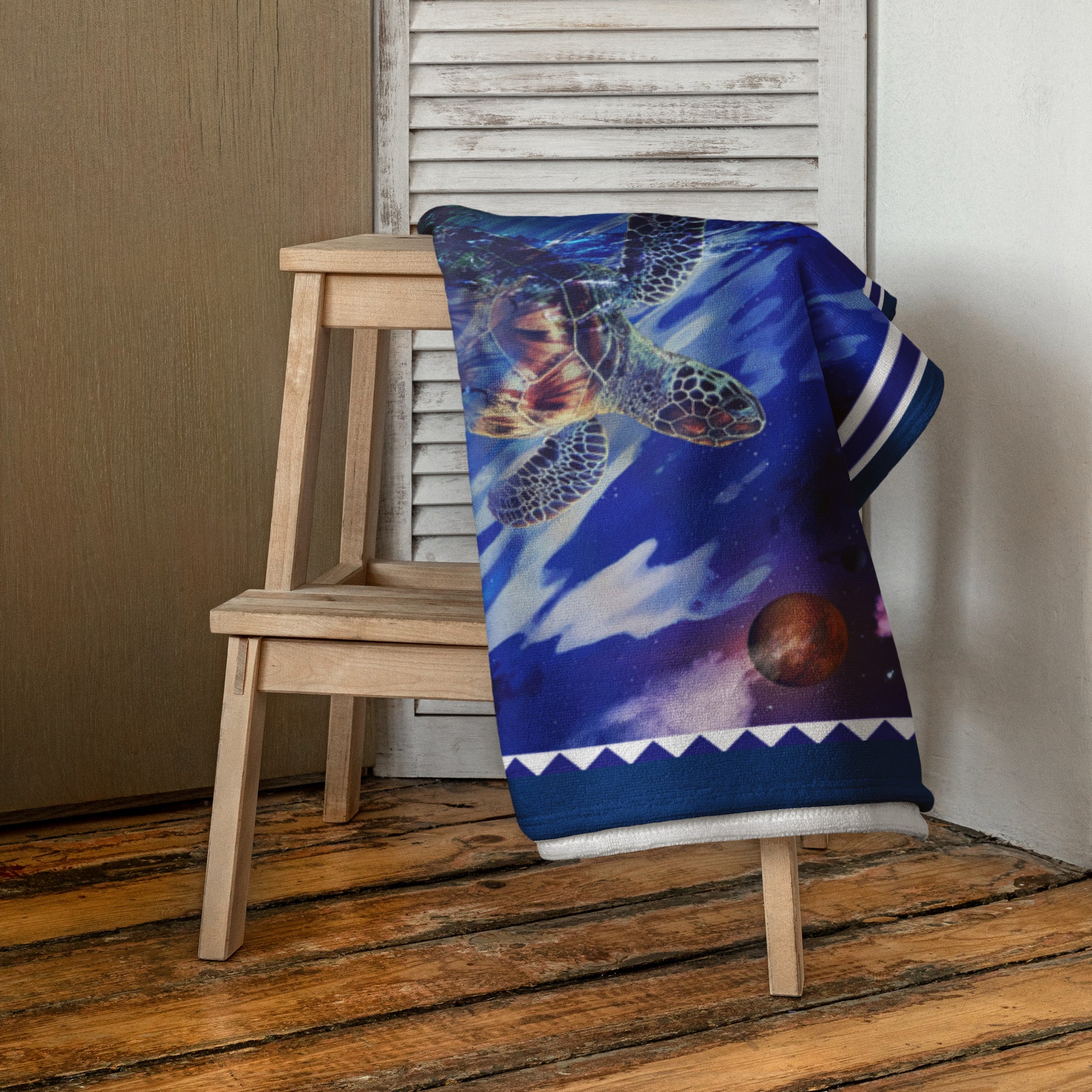 Lunar Waves geometric pattern on a Color in Motion beach towel 30x60 — folded and draped over wooden stool