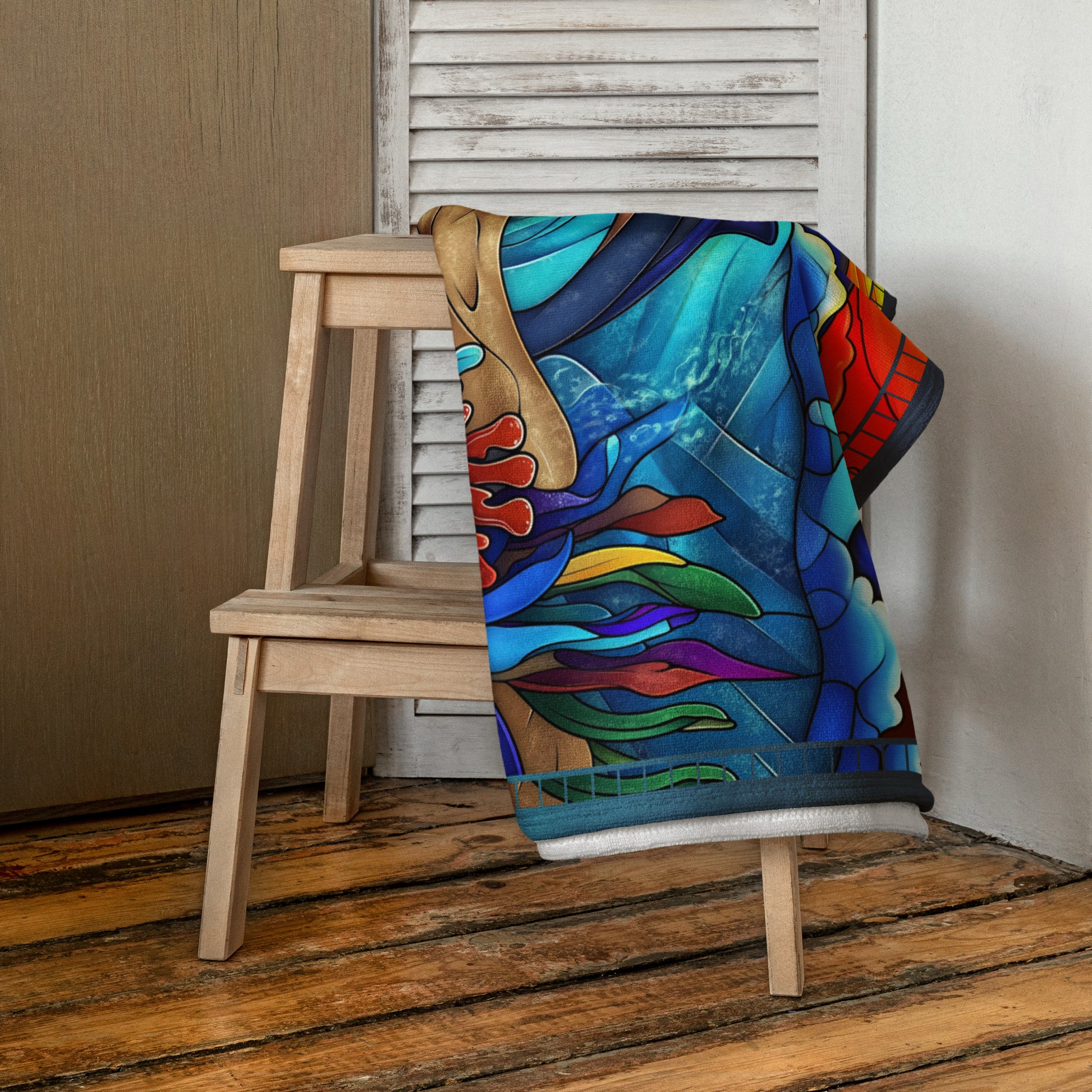 Dancing Tides geometric pattern on a Color in Motion beach towel 30x60 — folded and draped over wooden stool