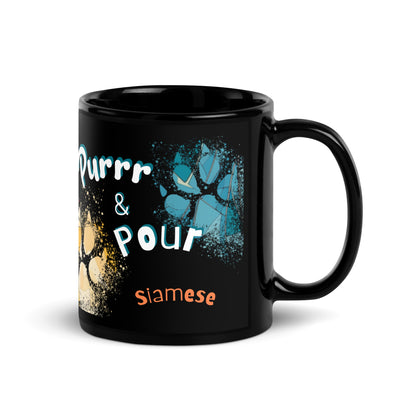 Purrr & Pour text with image of a Siamese cat on stained glass style background with colorful paw prints on a black ceramic mug 11 oz — handle on right
