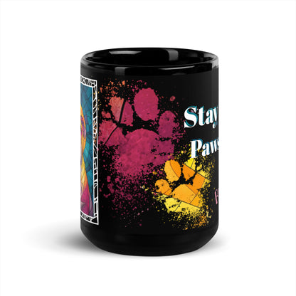 Stay Pawsitive text with image of a Bulldog on stained glass style background with colorful paw prints on a black ceramic mug 15 oz — front view