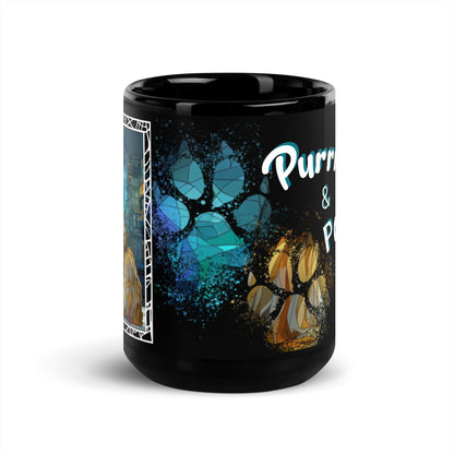 Purrr & Pour text with image of a Maine Coon cat on stained glass style background with colorful paw prints on a black ceramic mug 15 oz — front view