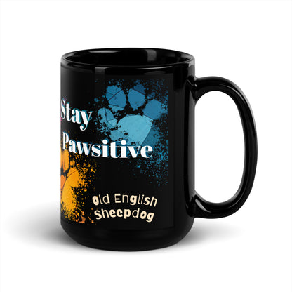 Stay Pawsitive text with image of a Old English Sheepdog dog on stained glass style background with colorful  paw prints on a black ceramic mug 15 oz — handle on right